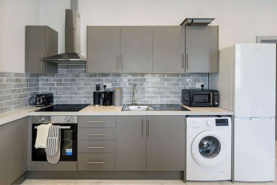 - Fully equipped kitchen with oven microwave fridge and washing unit  
- Ample counter space with coffee maker toaster and cookware provided  
- Ideal for longer Airbnb stays with all home style essentials ready  
