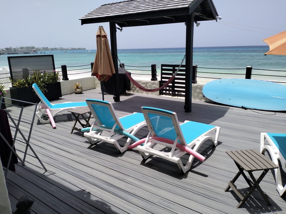 Enjoy direct beachfront access and soak up the sun on our spacious deck at Idle a While.
