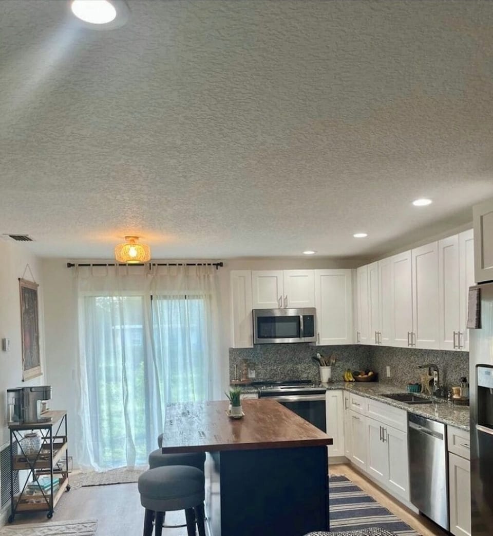 Kitchen features coffee bar and access to backyard oasis 