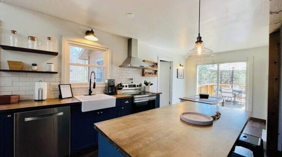 Kitchen Island with dining room by sliding glass door out to the back deck