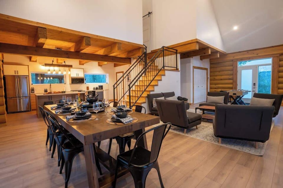Open-plan living and dining room with abundant windows for plenty of natural light.