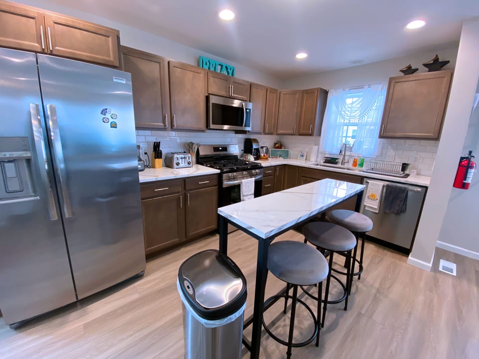 Full kitchen w/ fridge, microwave, stove, dishwasher, coffee maker, & essentials