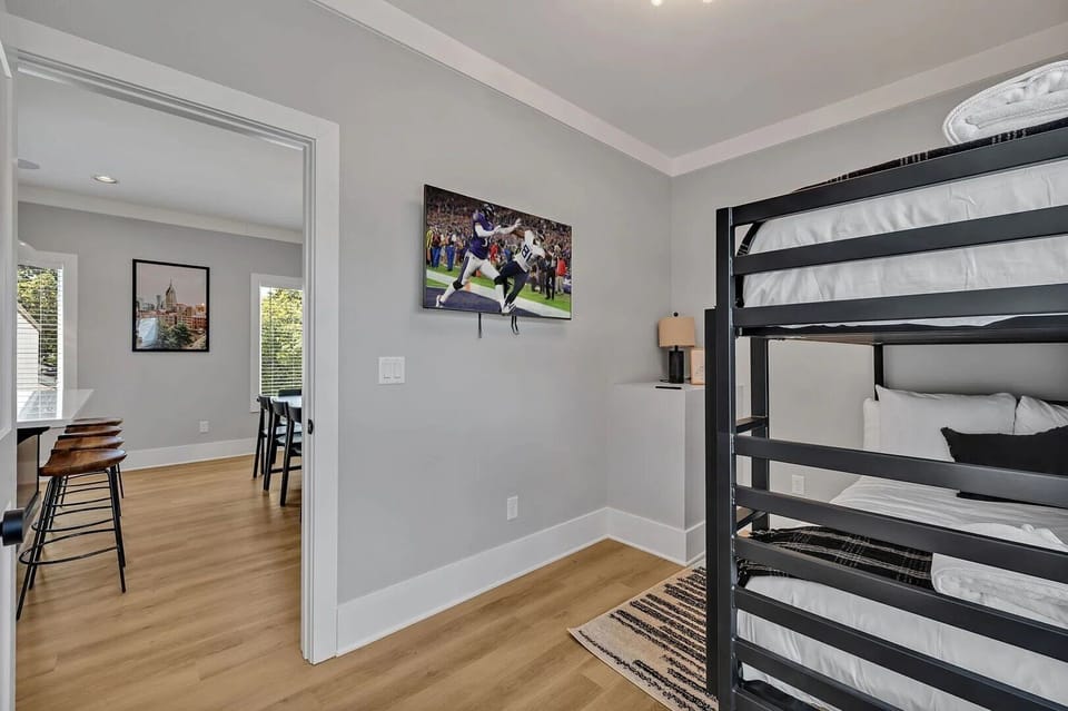 (Unit 1) 2nd Floor: 4th Bedroom featuring a bunk bed offering 2 Twin-sized mattresses, a closet space and a Smart TV for entertainment.