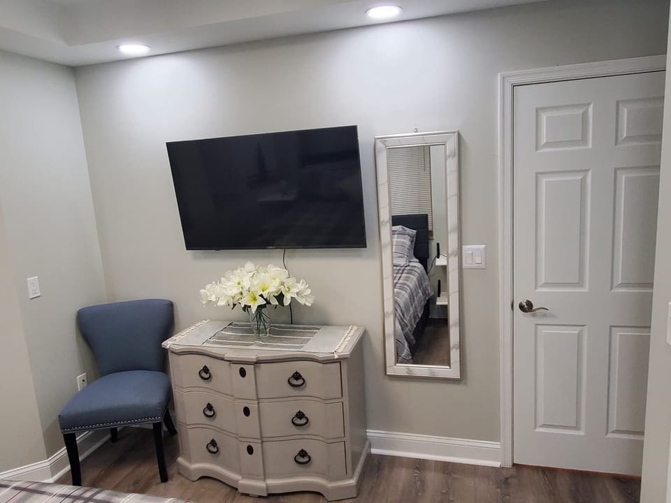 Bright elegant semi-master with queen bed, private bath, and 50" Wi-Fi smart TV