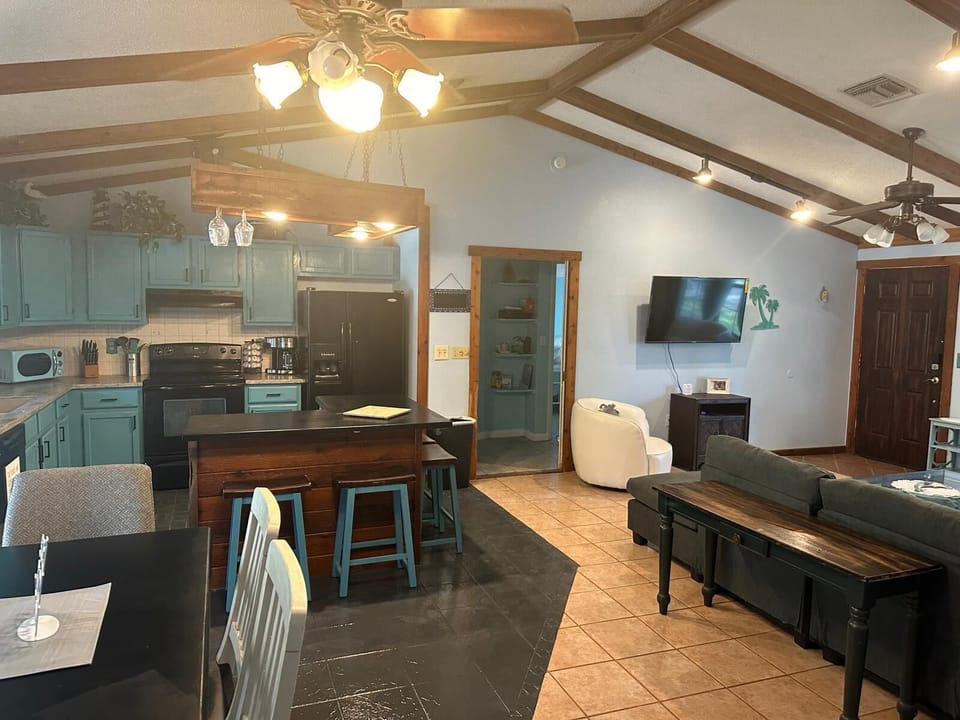 Large Living Space, Patio doors and 2 chairs for outdoor seating.  Also Grill 