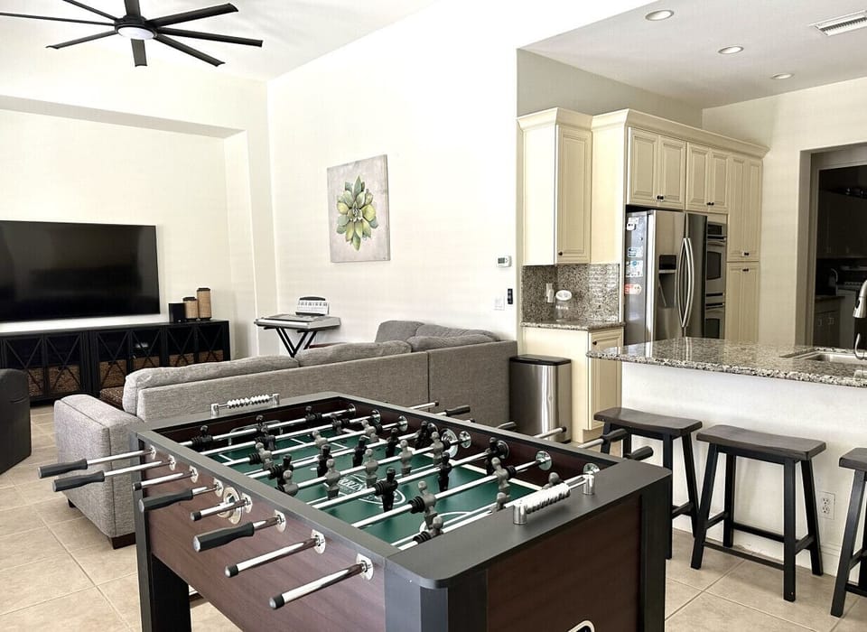 New Foosball table that has replaced the dining table, dining table moved to living area