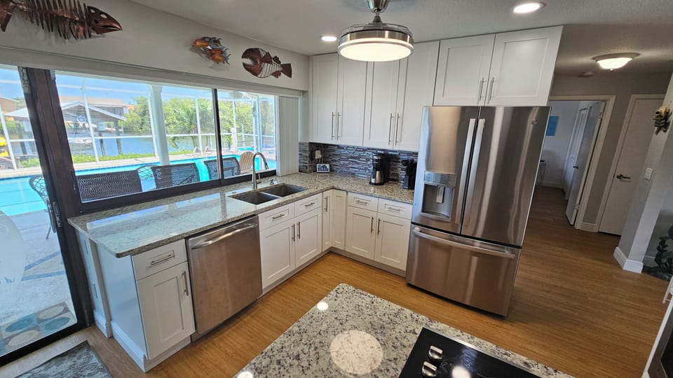 Updated kitchen overlooking the water and pool