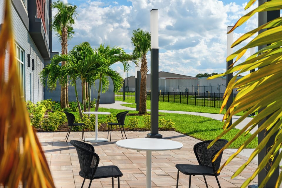 Sip morning coffee outdoors amid lush greenery and sunshine.