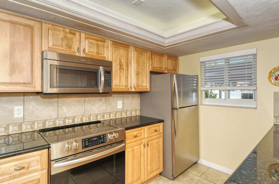 Kitchen - Stainless steel appliances and granite countertops.