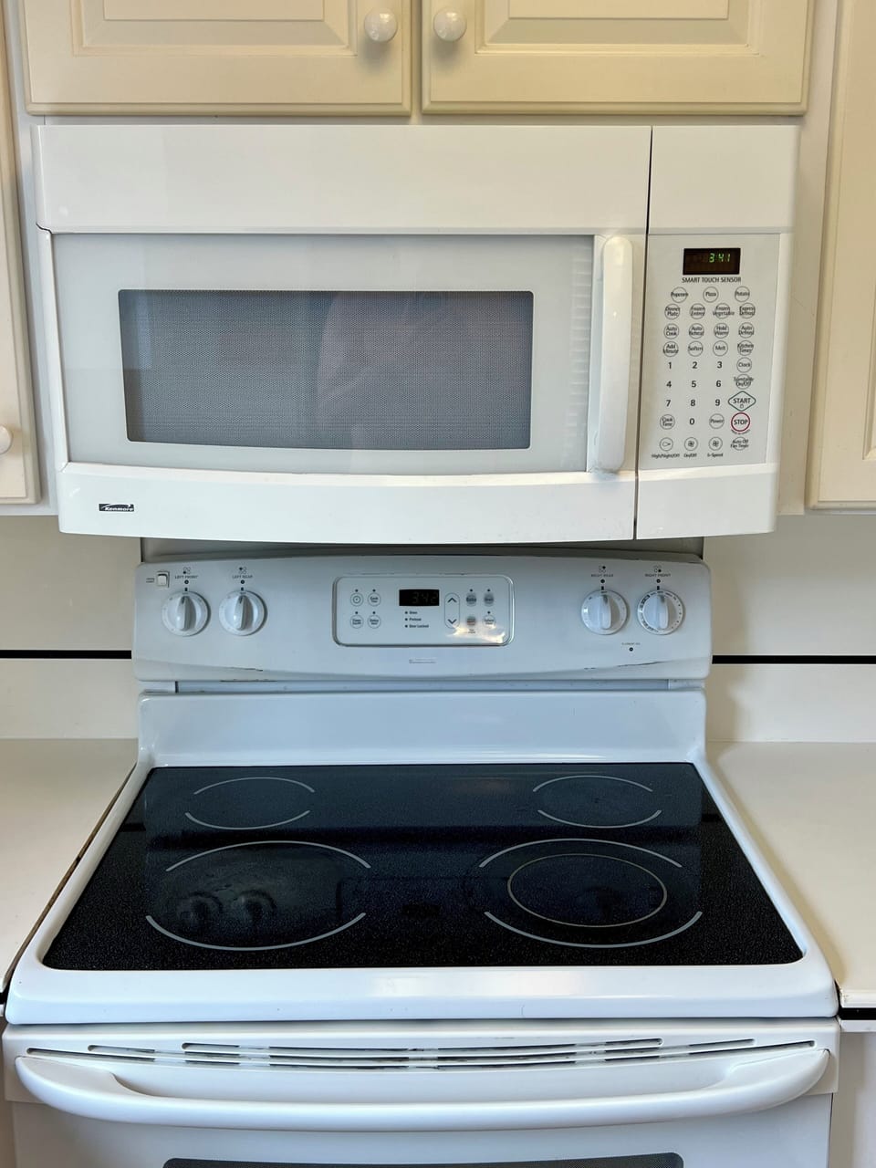 Glass top stove and range with full size microwave.