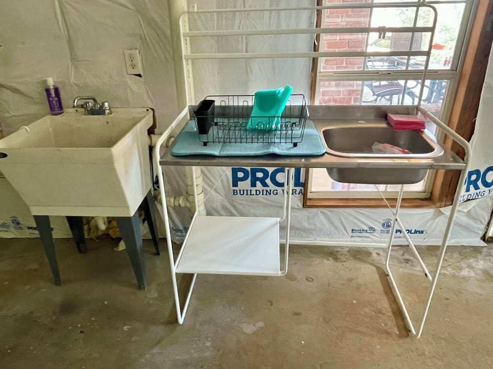 Small kitchen table provide in garage area to prep for grilling/small meal