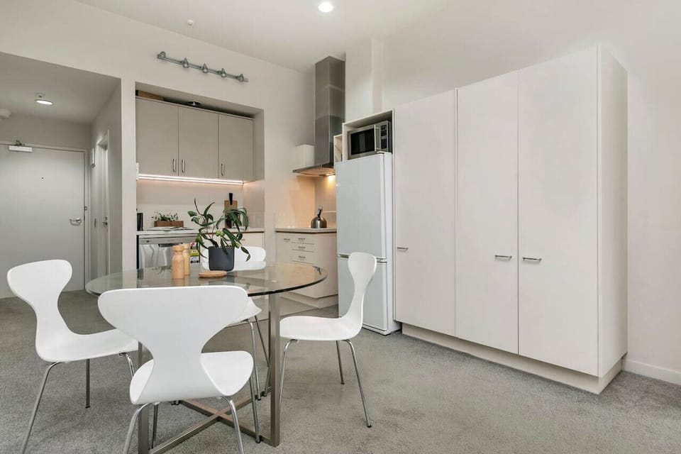 Stylish studio with a sleek open-plan kitchen, ample storage, and contemporary furnishings.