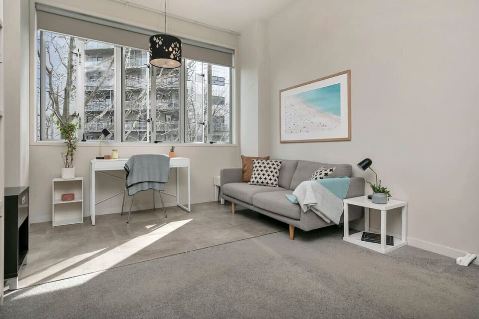 Unwind in this beautifully lit studio featuring floor-to-ceiling windows, a stylish sitting area, and a modern aesthetic. A perfect urban retreat for relaxation and productivity!