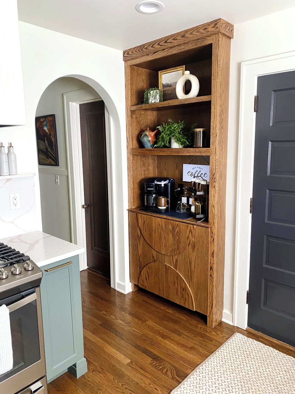 Kitchen coffee bar is fully stocked with coffee supplies stored in cabinet below