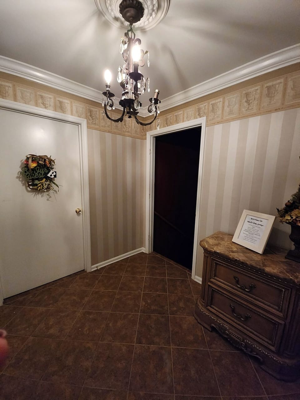 In foyer across the hall, suite B and down the stairs is the shared kitchen and living room.