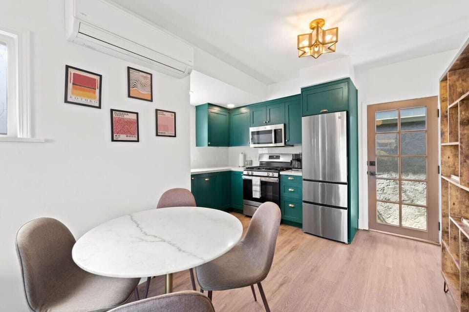 Charming dining nook w/ a round table, natural light & a cozy spot to gather for meals.