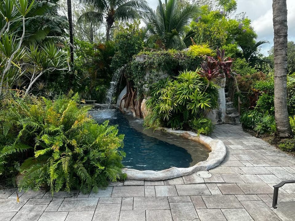 Tropical saltwater pool with steps to the cave roof.