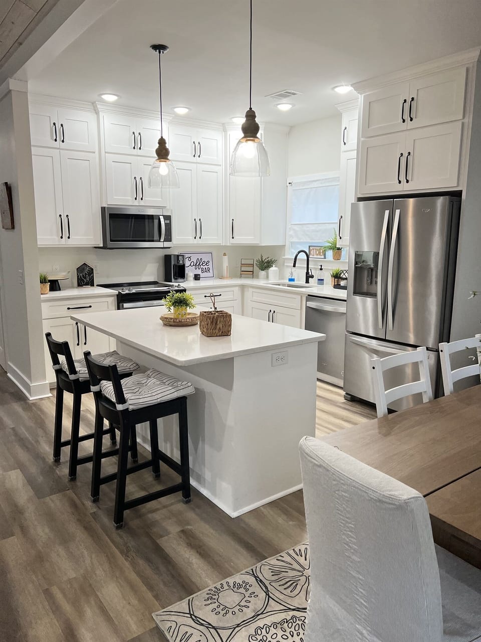 The spacious kitchen includes an island with 2 stools.