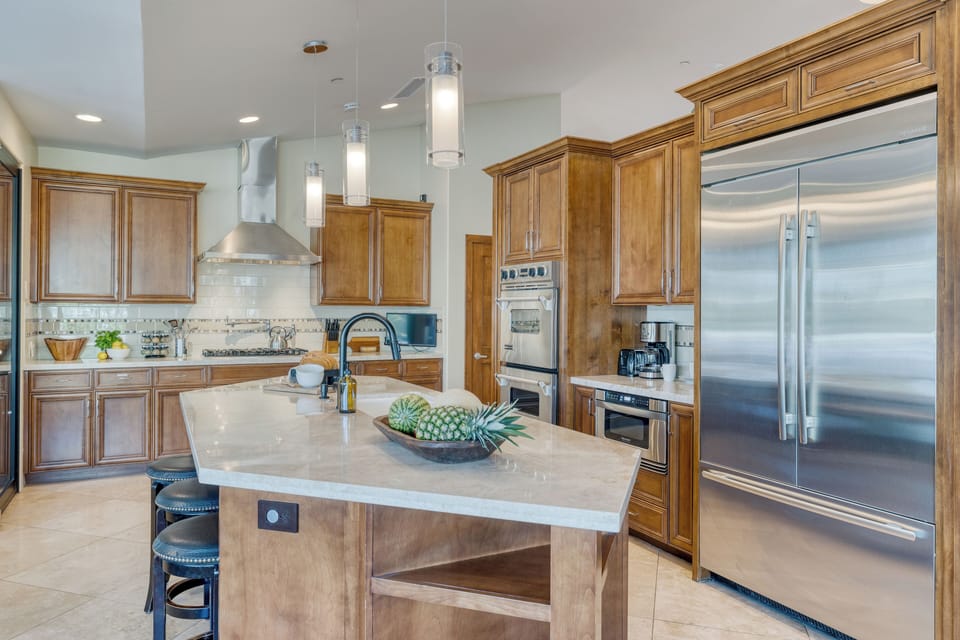 Enjoy barstool seating and high-end appliances in the kitchen.