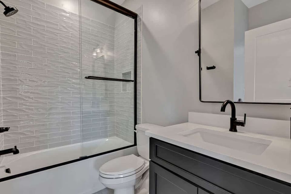 Unit 1 - 2nd Floor: 3rd Bathroom - Off the kitchen features a single vanity and a shower/tub combo.