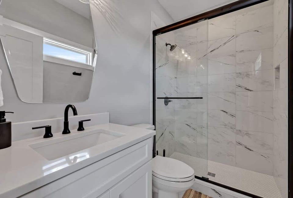 Unit 1 - 3rd Floor: Primary Bathroom featuring a single vanity and a luxurious stand-in shower.