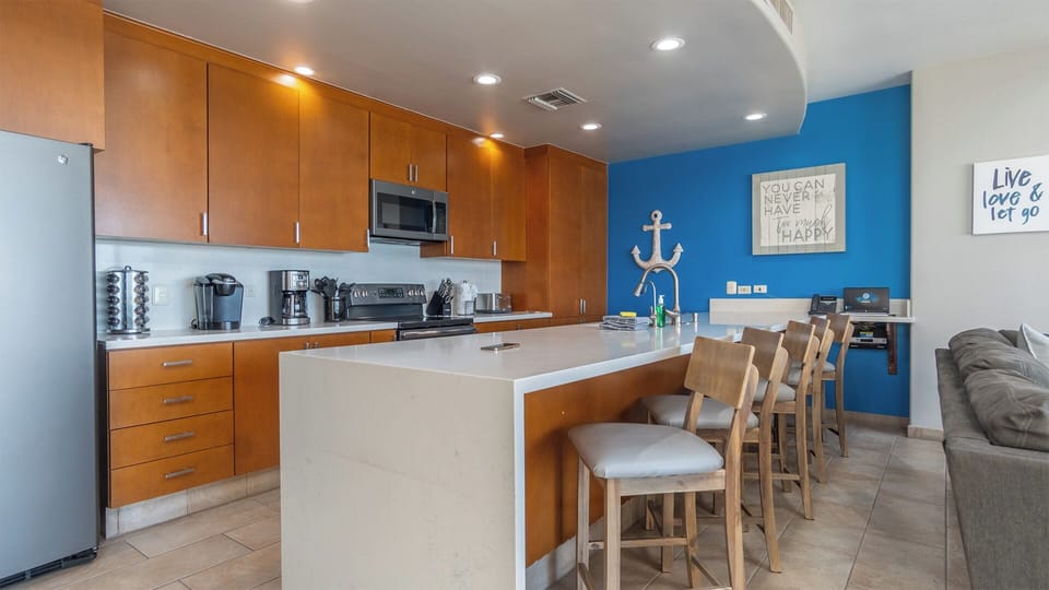 Long counter island and seats in th kitchen.