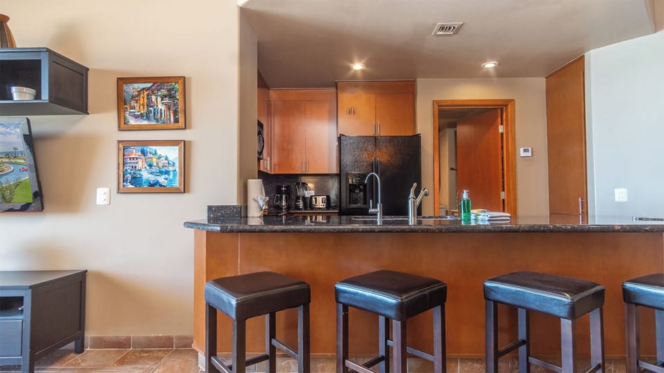 Leather bar stools at the kitchen counter.