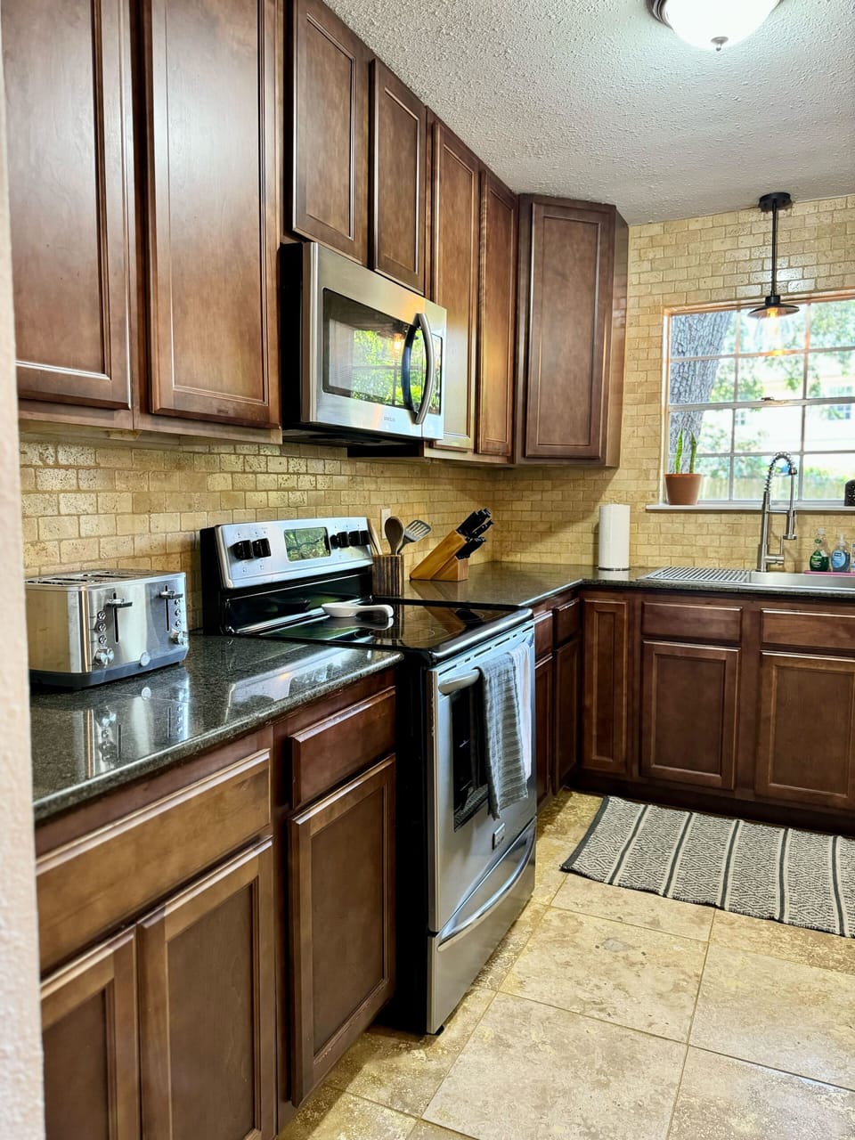 kitchen with toaster, oven, and microwave 