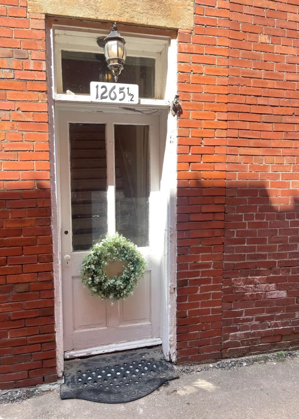 Located in the ally on the North side of the located on the north side building