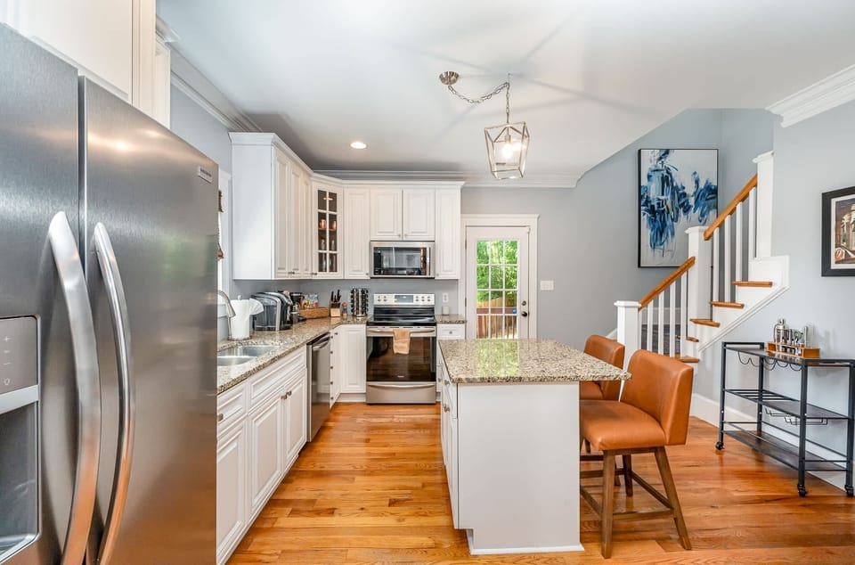 Experience our kitchen hub designed for versatility, offering seating with a table for everything from mealtime gatherings to productive work sessions and leisurely reading.