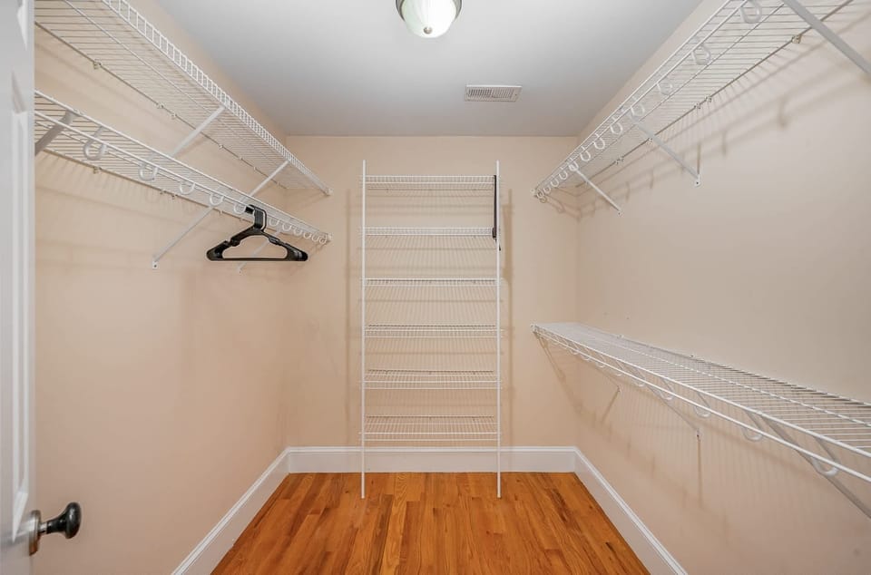 Enjoy the convenience of our well-appointed dressing room, featuring generous hanging areas, versatile shelves for folded clothes, and ample space for luggage and bags, designed for optimal organization and comfort.