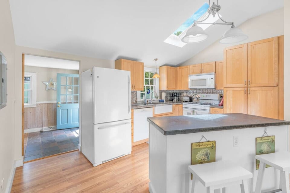 Beautiful fully-equipped kitchen with a skylight and all the appliances & utensils you could need to enjoy a home cooked meal.