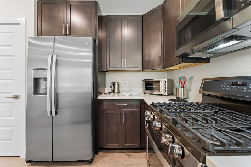 Full size kitchen with stainless steel appliances.