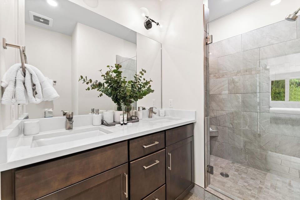 Unwind in your elegant marble bathroom with luxurious finishes, plush towels, and a spa-like walk-in shower.