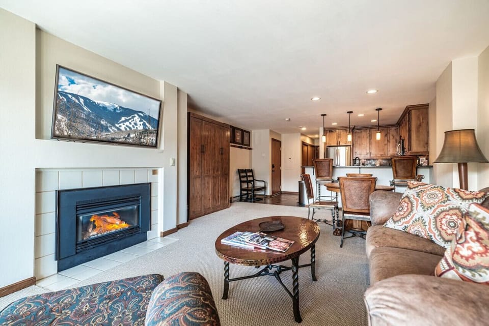 Open kitchen and living area with a rustic feel and modern fireplace