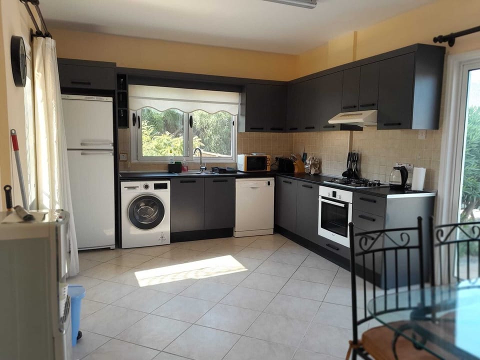 Kitchen with fridge freezer, washing machine and dishwasher. 