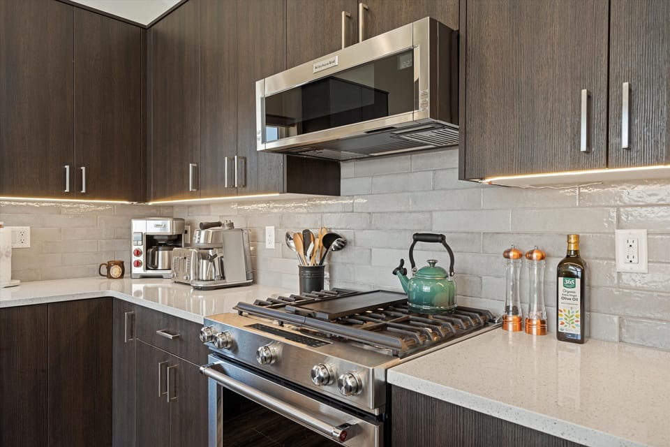A gas stove with a griddle, coffee maker, toaster, microwave, and all new appliances make this kitchen a cook's dream.