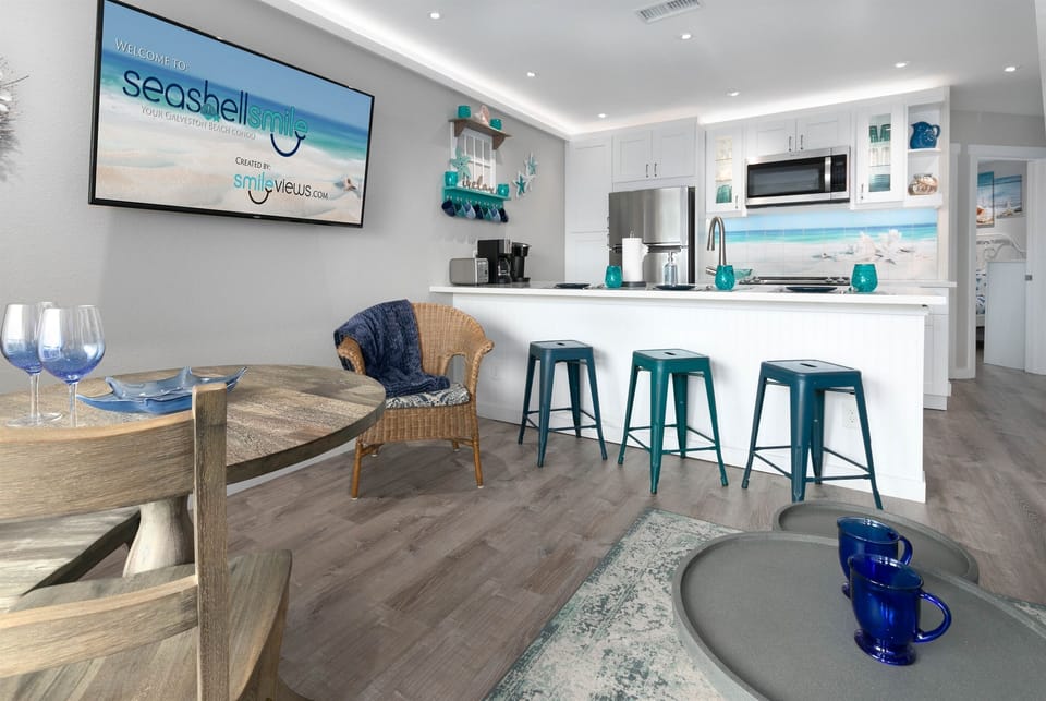 Flat panel smart TV's in den and bedroom.  Open concept den and kitchen.
