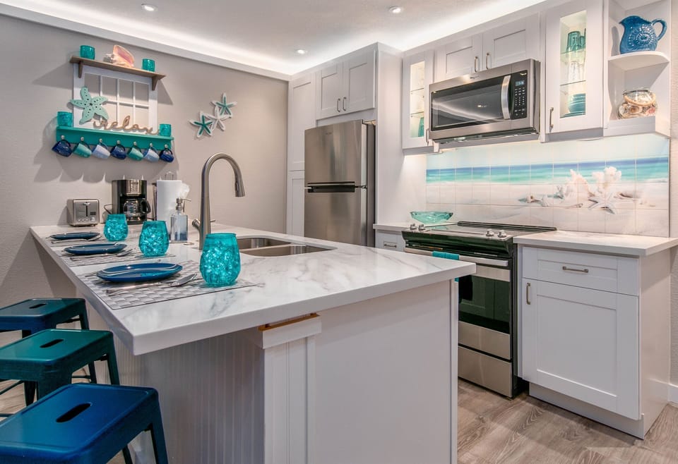 Tropical colors and custom backsplash make this condo truly unique!