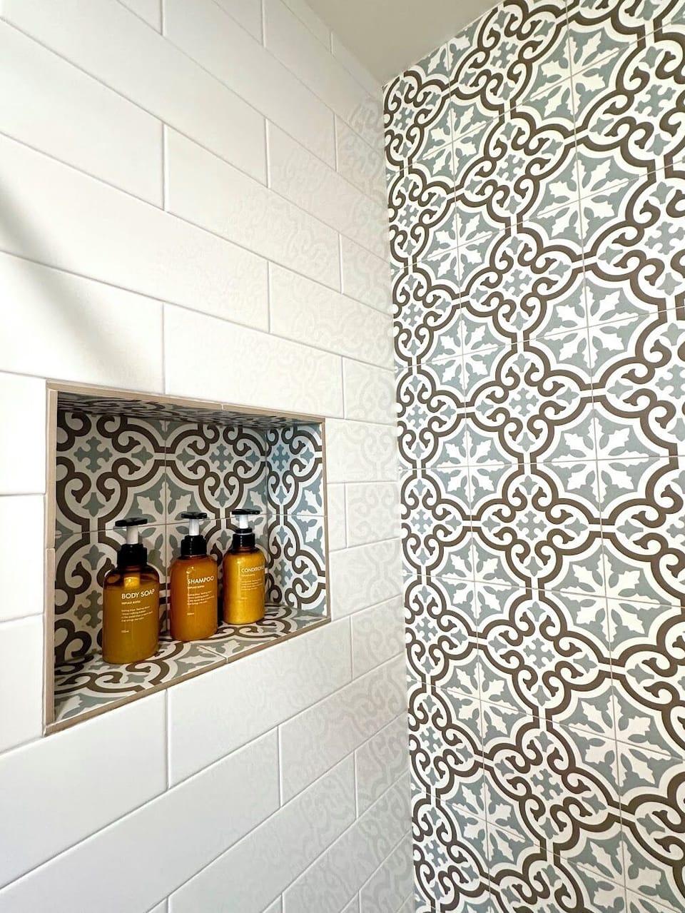 Hall bathroom with custom tile, heated floors and toiletries.