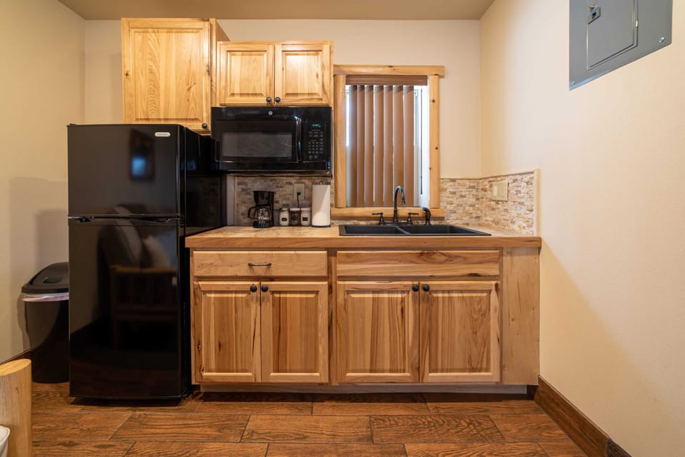 The kitchenette includes a mini fridge, coffee maker, kitchen sink and microwave.