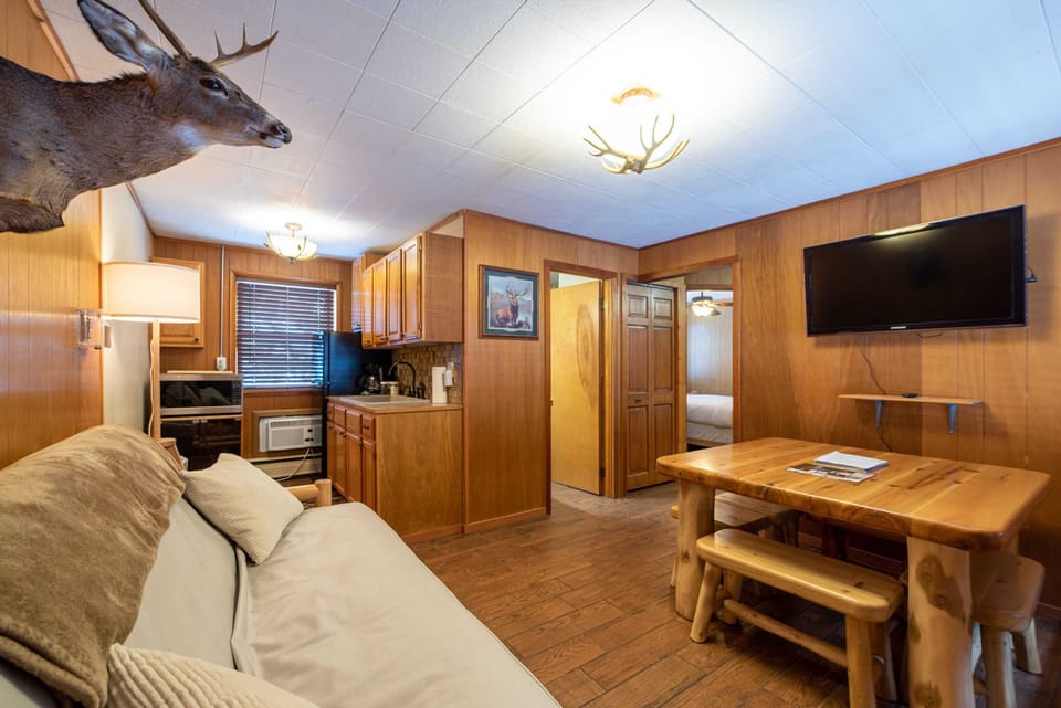 Log wood furniture cabin with an open floor plan.