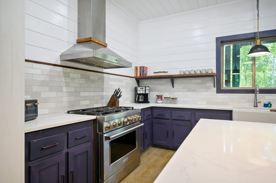 The kitchen is full of stainless steel appliances.