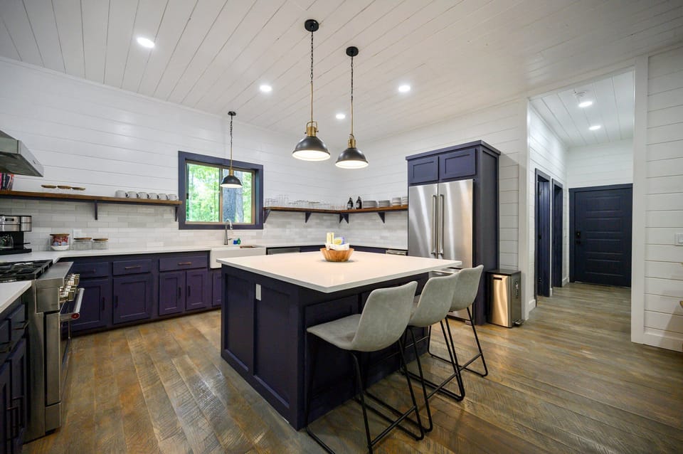 The fully equipped kitchen with 3 seats at the island.