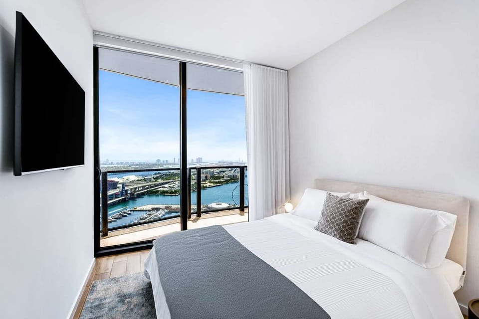 Wake up to sparkling bay views from your plush bed.