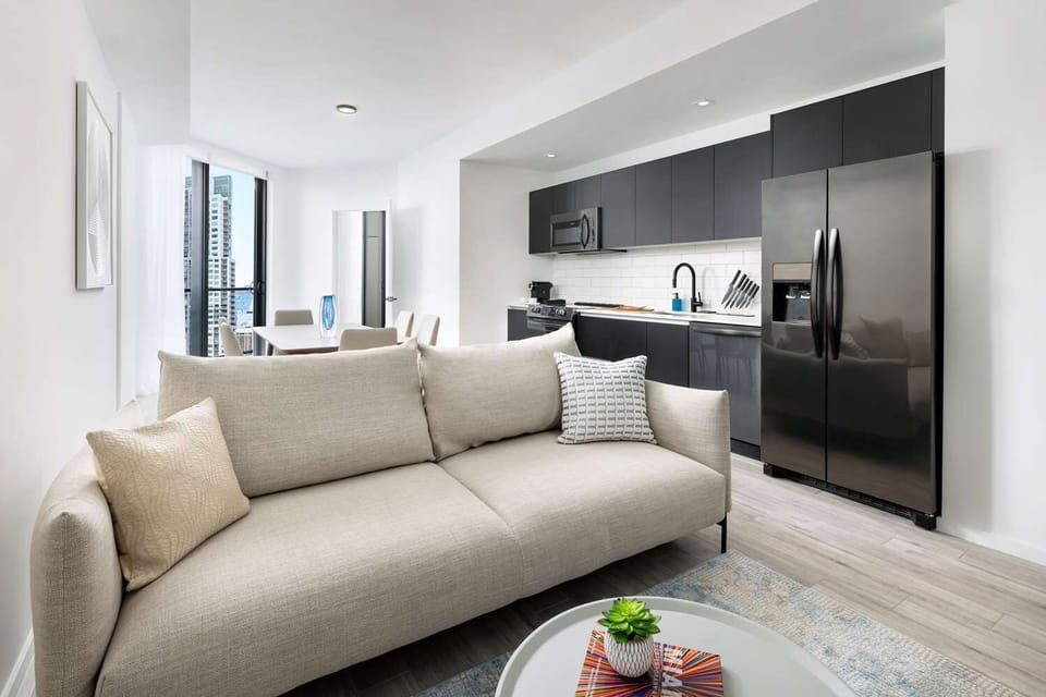 Lounge comfortably in bright open-plan space with modern kitchen.