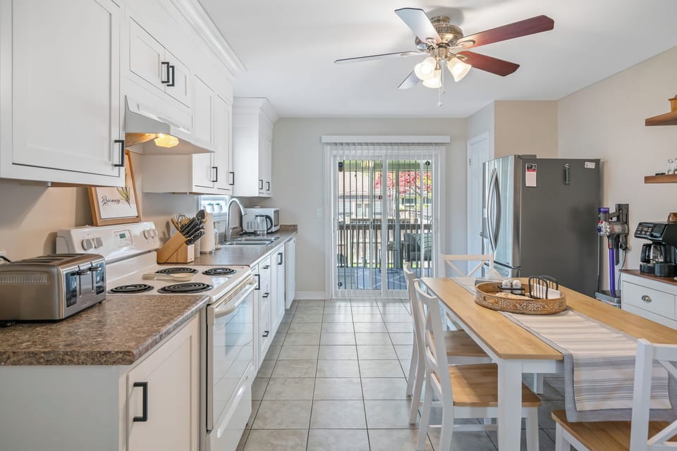 Full kitchen and patio doors leading to back deck.