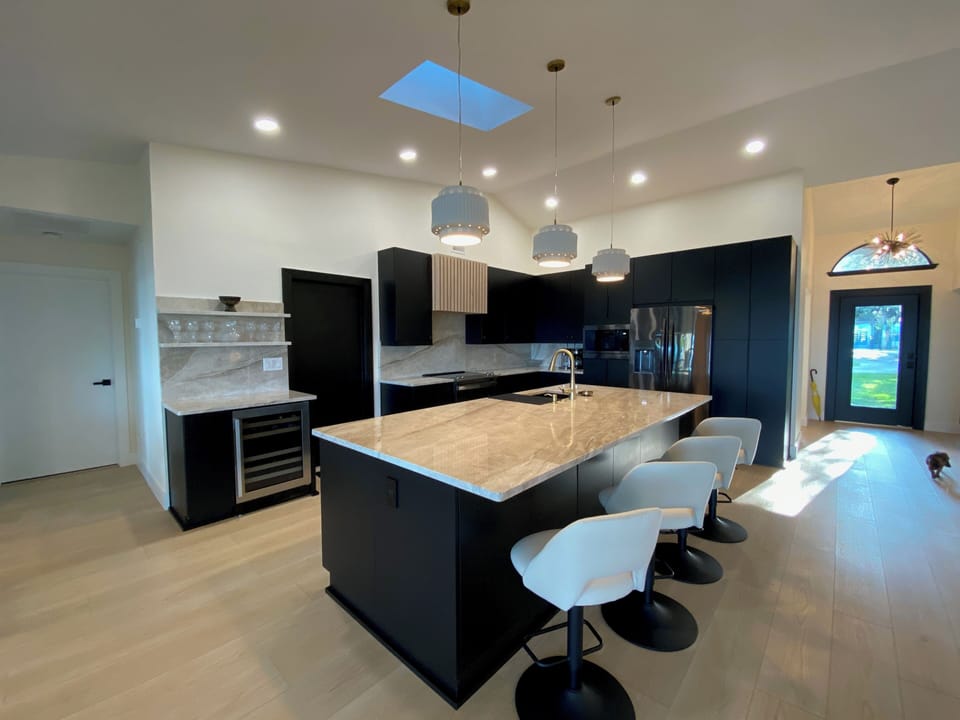 Wine cooler with dual temperature zones, wine glasses on floating shelves above.