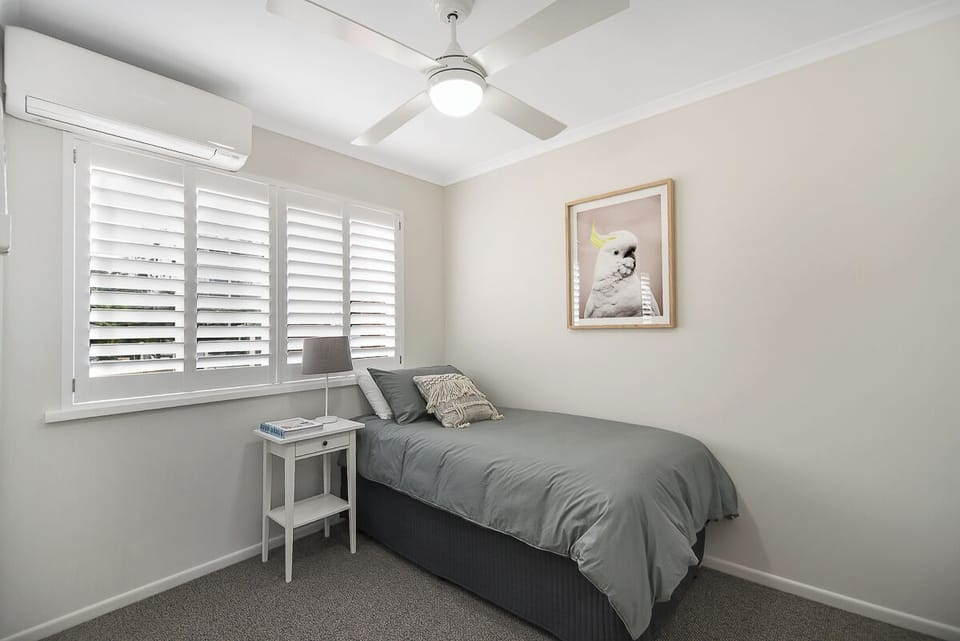 Second bedroom with single bed and separate single trundle bed