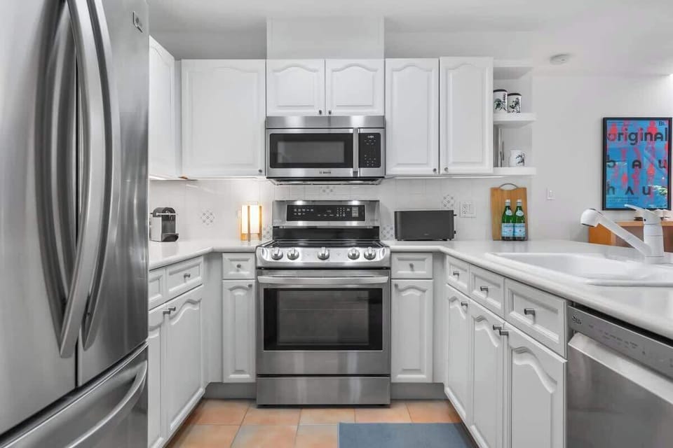 - Fully equipped kitchen with stainless steel appliances and cookware  
- White cabinetry and sleek countertops perfect for meal prep  
- Ideal setup for long stays or family cooking nights in Whistler  

